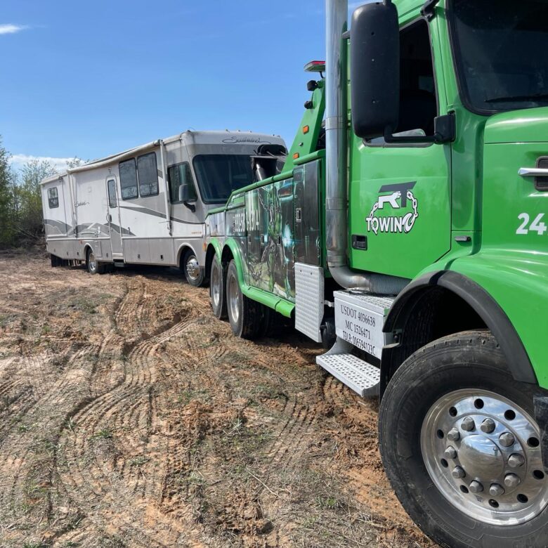 green truck towing a RV