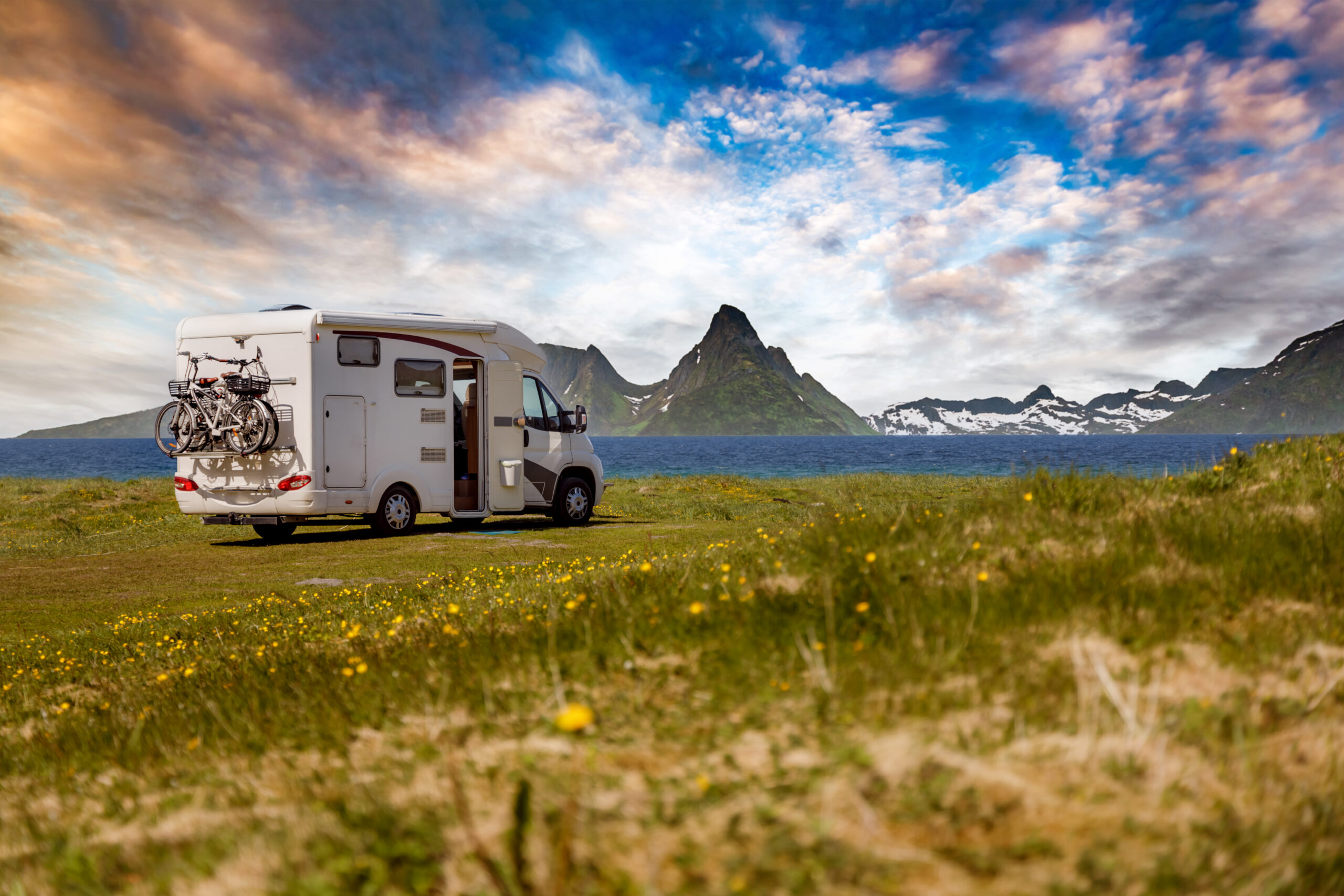 RV parked by a lake with bikes, potential job for wrecker Houston.