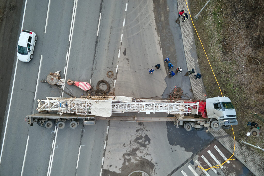 Overhead view of a crane on a truck in a street cleanup by wrecker Houston.